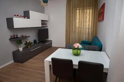 a living room with a white table and chairs at Ostiense 73 in Rome