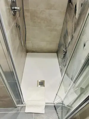 a shower stall with a white seat in a bathroom at Appartamento Lilly's Home Piazza Navona in Rome