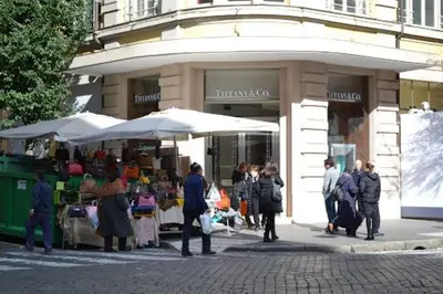 a group of people standing in front of a market at AD 111 ColaDiRienzo Rooms - by AD Roma in Rome