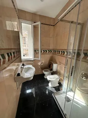 a bathroom with two toilets and a sink and a shower at ULPIANO SUITE Vaticano Centro in Rome