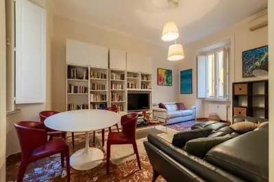 a living room with a table and a couch at JOIVY Charming 3BR flat near the Vatican in Rome