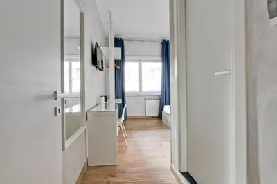 a hallway with a desk and a kitchen with a window at Marble Rooms in Rome
