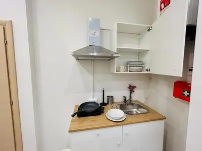 a small kitchen with a sink and a microwave at Domus Giolitti in Rome