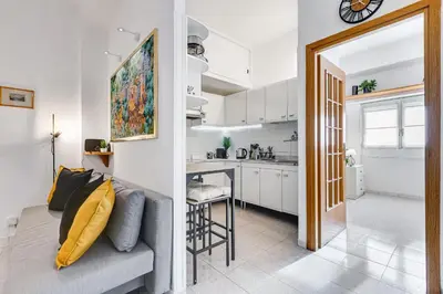 a living room with a couch and a kitchen at Casa San Paolo in Rome