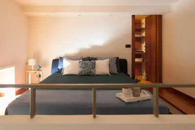 a bedroom with a bed with pillows on it at Chez David in Rome