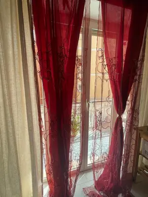 a window with red curtains in a room at Casetta Maria Pia near Metro A Cornelia in Rome