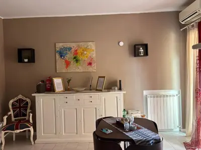 a living room with a white cabinet and a table at Casetta Maria Pia near Metro A Cornelia in Rome