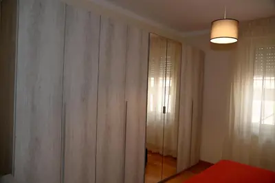 a room with a closet with curtains and a window at Casetta via delle Cave in Rome