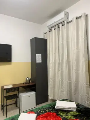 a room with a desk and a curtain at TURATI TERMINi in Rome