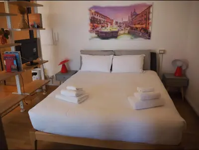 a bedroom with a white bed with towels on it at Casa Aurelia 641 in Rome