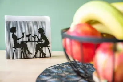 a book with a picture of people sitting at a table at Olimpia House - Gianicolense in Rome