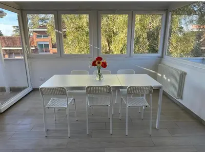 a white table and chairs in a room with windows at Home34 in Rome