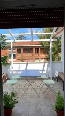 a blue table and chairs on a patio at Home34 in Rome