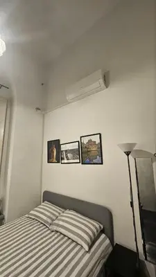 a bedroom with a bed and three pictures on the wall at DidiHouse in Rome