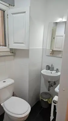 a white bathroom with a toilet and a sink at DidiHouse in Rome