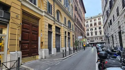a city street with buildings and motorcycles parked on the street at DidiHouse in Rome