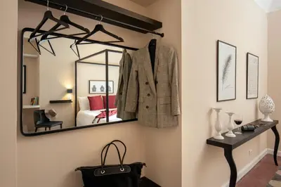 a dressing room with a suit and a mirror at Emperor's View in Colosseum in Rome