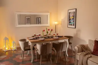 a dining room with a table with wine glasses at Emperor's View in Colosseum in Rome