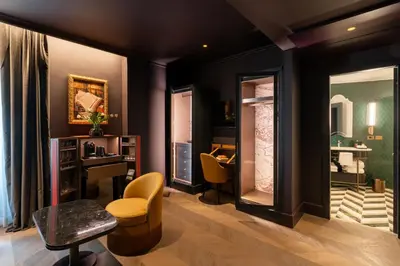a room with a desk and chairs and a mirror at The Goethe Hotel - Small Luxury Hotels of the World in Rome