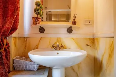 a bathroom with a white sink and a mirror at Parcheggio Privato - Villa Liberty Roma Centro in Rome