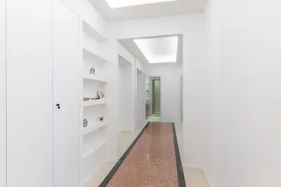a hallway with white walls and a skylight at DOMUS LUX ANGELICA- Nearby Vatican in Rome