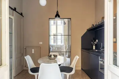 a dining room with a table and chairs at GuestHost - Central and Modern apartment in Rione Monti in Rome