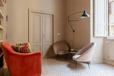a living room with two chairs and a table at GuestHost - Central and Modern apartment in Rione Monti in Rome