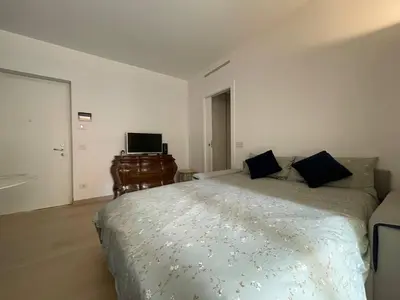 a bedroom with a large bed and a desk at Easylife - Vatican Terrace Apartment in Rome