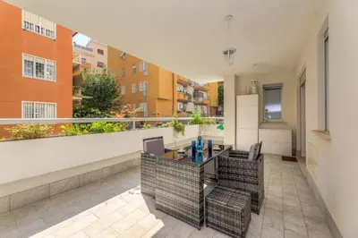 an apartment with a balcony with a table and chairs at Easylife - Vatican Terrace Apartment in Rome