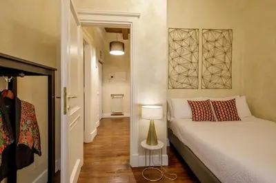 a small bedroom with a bed and a lamp at Spanish Steps Boutique Apartment in Rome