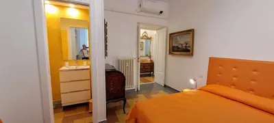 a bedroom with an orange bed and a bathroom at Machiavelli Forty Seven in Rome