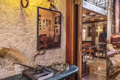 a room with a stone wall with a bench and a mirror at The Eleanor Secret Studio - Campo de' Fiori in Rome