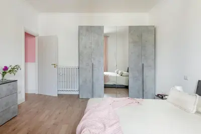 a bedroom with a bed and a large mirror at Luxury Pink apartment in Rome