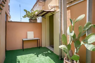 a small balcony with a table and a plant at Luxury Pink apartment in Rome