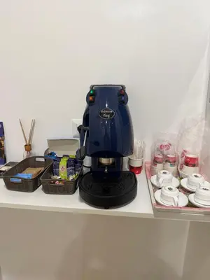 a blue coffee maker sitting on top of a counter at Vatican Bliss in Rome