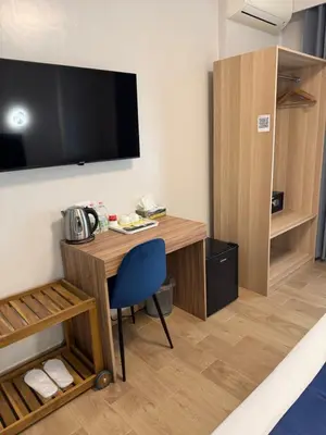 a room with a desk and a tv on the wall at Vatican Bliss in Rome