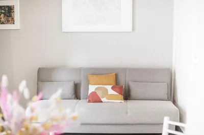 a gray couch with pillows in a living room at Casina Bianca in Rome