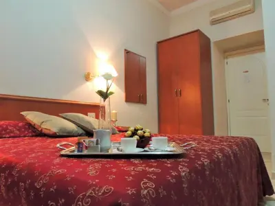 a tray with two cups of coffee on a bed at Florida rooms - comfort Hotel in Rome