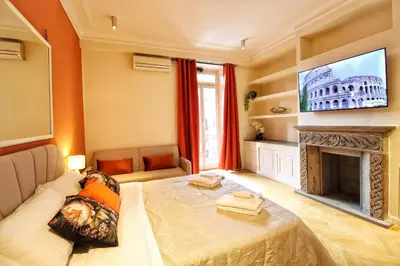 a living room with a fireplace and a tv at Domus Mazzini in Rome