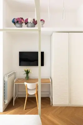 a bedroom with a desk and a tv on a wall at Iflat New Spacious & Classy Apartment in Monti in Rome