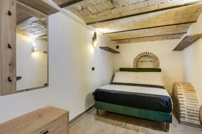 a small bedroom with a bed and a mirror at Oliviero - Piazza Navona Apartment in Rome