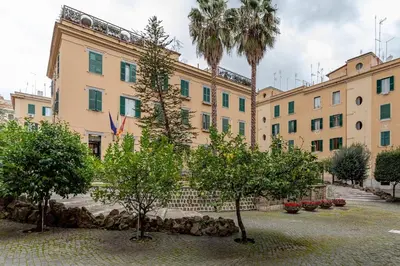 a large building with trees in front of it at Domus Adriana Ada - adiacente metro A in Rome