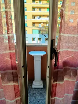 a table in a room with a window at Chez Michel in Rome
