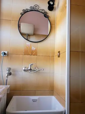 a bathroom with a sink and a mirror at Chez Michel in Rome