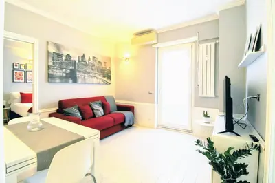 a living room with a red couch and a tv at Casa di Lola Metro Conca d' Oro in Rome