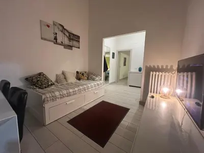 a living room with a couch and a mirror at Statilia Urban Retreat in Rome