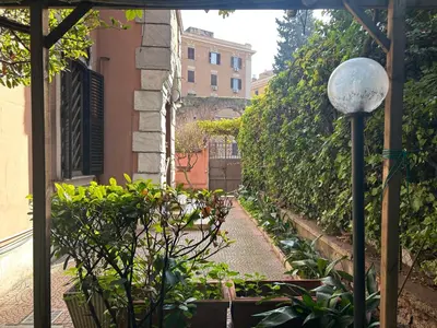 a garden with some plants and a street light at Statilia Urban Retreat in Rome