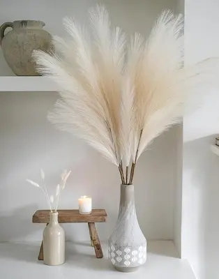 a vase with feathers in it next to a table at Elegance Penthouse 959 in Rome