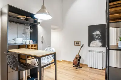 a dining room with a table and a guitar at L'Arte Dei Sogni Apartment With Terrace- Trastevere District in Rome
