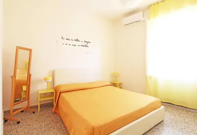 a small bedroom with a bed and a mirror at Julia Apartment in Rome
